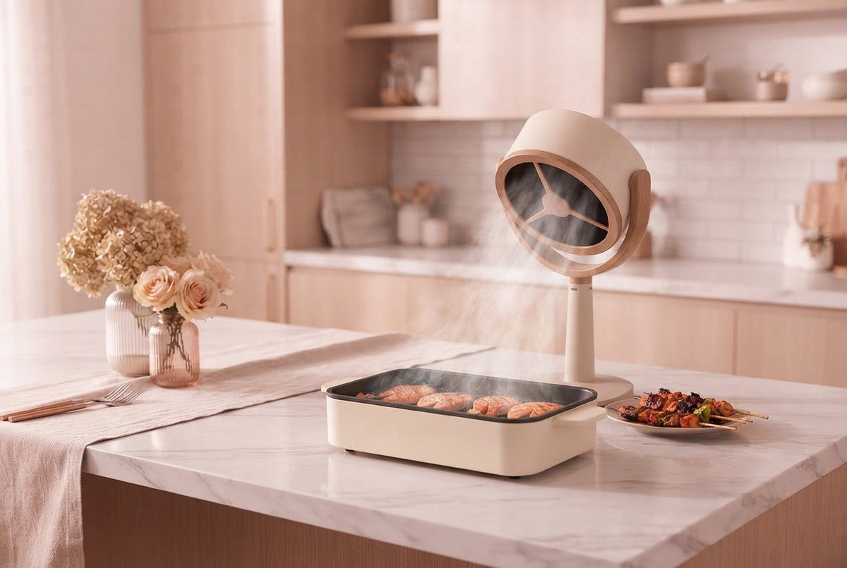 A portable air purifier placed on a kitchen island surrounded by blush-colored decor in a bright modern kitchen.